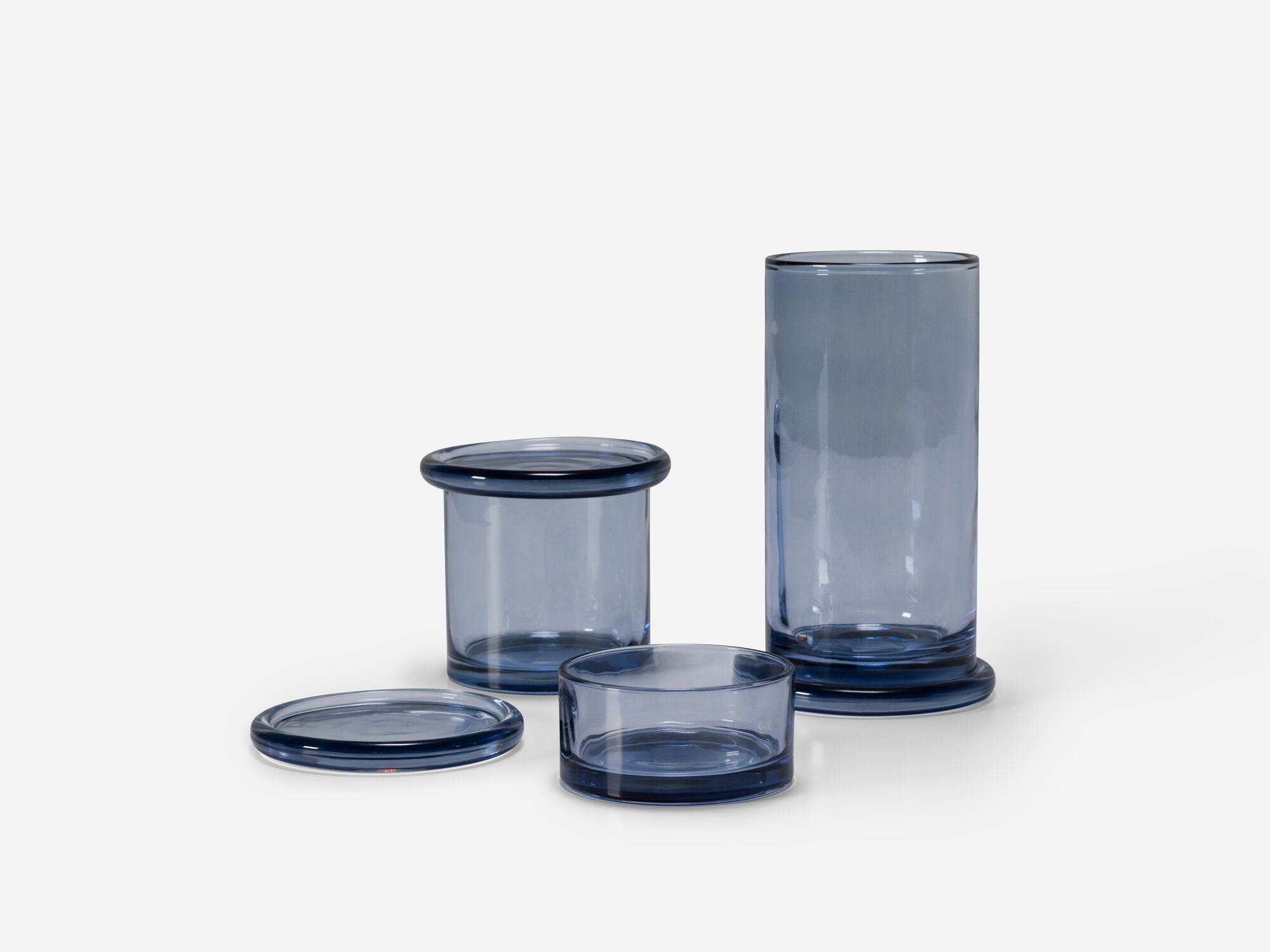 Front view of three glass organization containers with lids